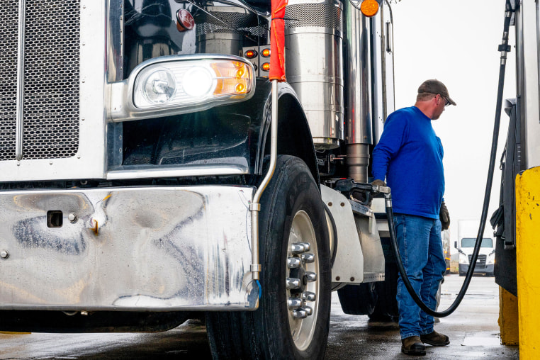 A man refills his diesel truck.