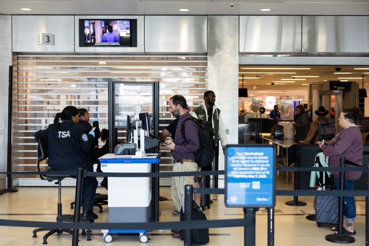Travelers wait in line at a Transportation Security Administration (TSA) checkpoint at Philadelphia International Airport (PHL) in October 2025 in Philadelphia.