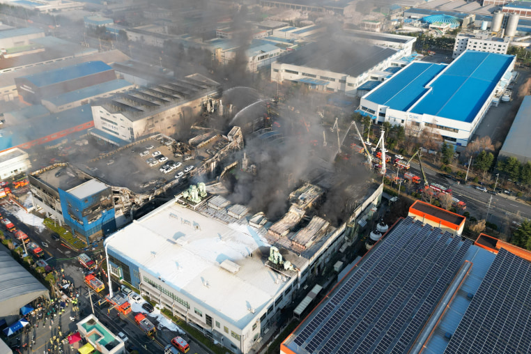 Firefighters spray water to extinguish a fire at a car parts plant in Daejeon on March 20.