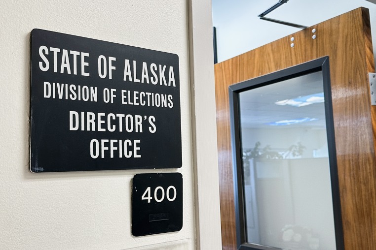 A sign hangs outside the director's office of the Alaska Division of Elections