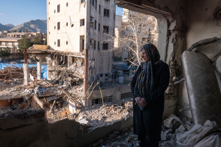 A woman named Narges looks out from her destroyed apartment in the remains of a residential and commercial building on March 21, in the Shahrak-e Gharb neighbourhood of Tehran, Iran. 