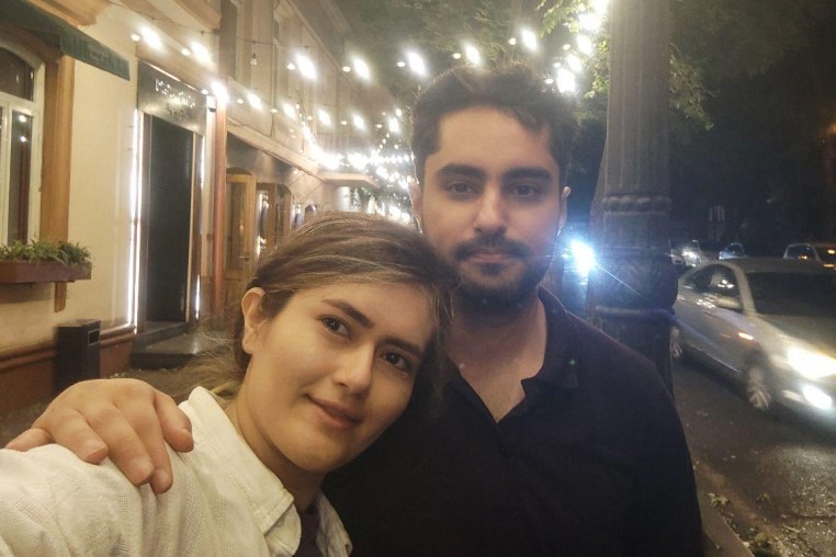 Safa Sefidgari, left, and her husband Ehsan Entezari stand outside for a selfie