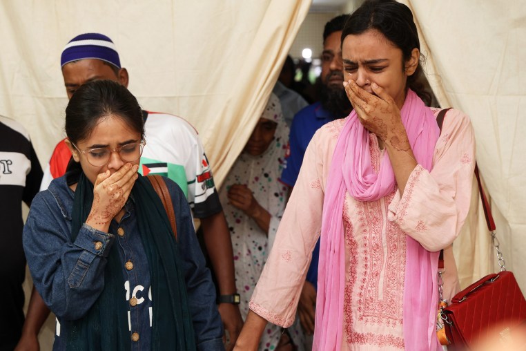 Image: Relatives of victims crying at Rajbari Government Hospital