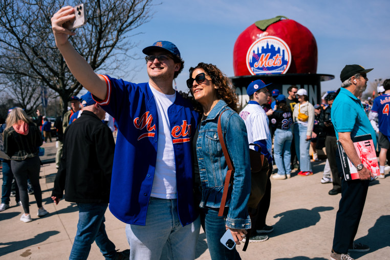 Fans take selfies as they arrive at Citi Field for an opening-day baseball game between the New York Mets and the Pittsburgh Pirates