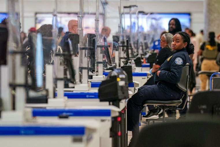 A TSA agent at a screening checkpoint.