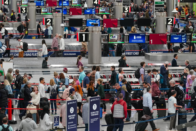 Travelers wait in line at a Transportation Security Administration (TSA) checkpoint at Hartsfield-Jackson Atlanta International Airport (ATL) in Atlanta, Ga. on Friday.