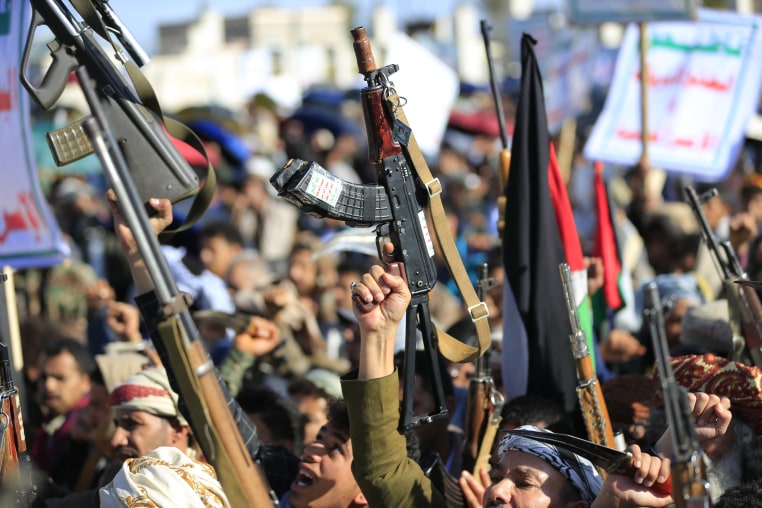 Houthis brandish their weapons as they rally in solidarity with Iran and Lebanon, amid the US-Israeli war with Iran, in the Yemeni capital Sanaa.