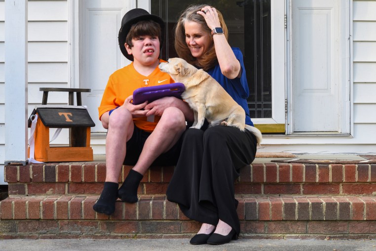 Kim Stephens and her son Cole on the front porch of their home with their dog, Rosie. Carrboro, NC. March 29, 2026.