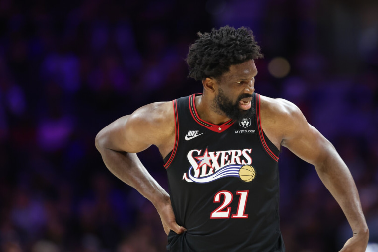 Feb 26, 2026; Philadelphia, Pennsylvania, USA; Philadelphia 76ers center Joel Embiid (21) reacts while clutching his body after a play against the Miami Heat during the second quarter at Xfinity Mobile Arena. Mandatory Credit: Bill Streicher-Imagn Images