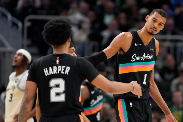 Mar 28, 2026; Milwaukee, Wisconsin, USA; San Antonio Spurs forward Victor Wembanyama (1) and guard Dylan Harper (2) shake hands during the fourth quarter against the Milwaukee Bucks at Fiserv Forum. Mandatory Credit: Jeff Hanisch-Imagn Images