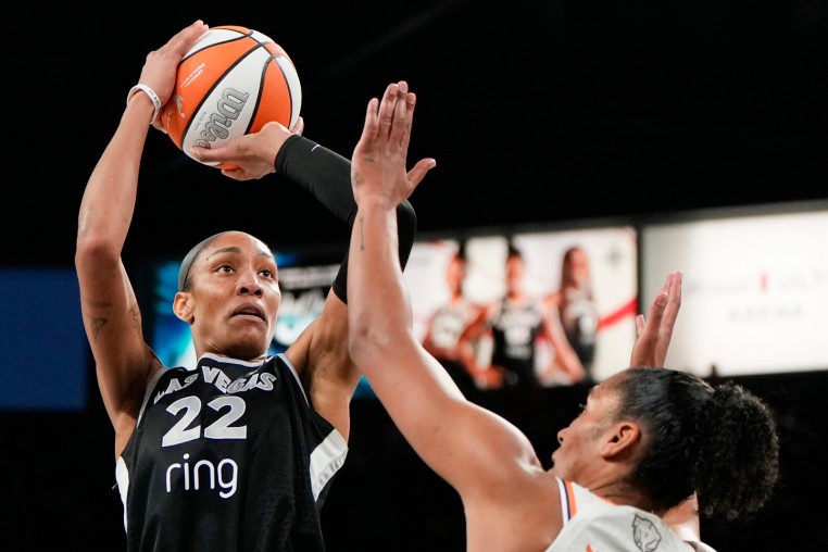 Oct 5, 2025; Las Vegas, Nevada, USA; Las Vegas Aces center A'ja Wilson (22) shoots the ball against Phoenix Mercury forward Alyssa Thomas (25) during the fourth quarter of game two of the 2025 WNBA Finals at Michelob Ultra Arena. Mandatory Credit: Lucas Peltier-Imagn Images