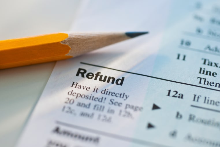 A pencil lays on top of a refund form