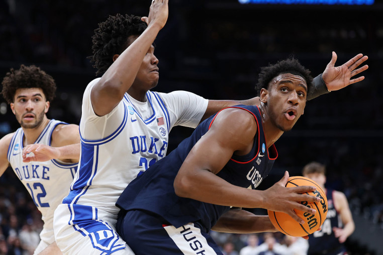 UConn's Tarris Reed drives around Patrick Ngongba of the Duke Blue Devils on March 29, 2026.