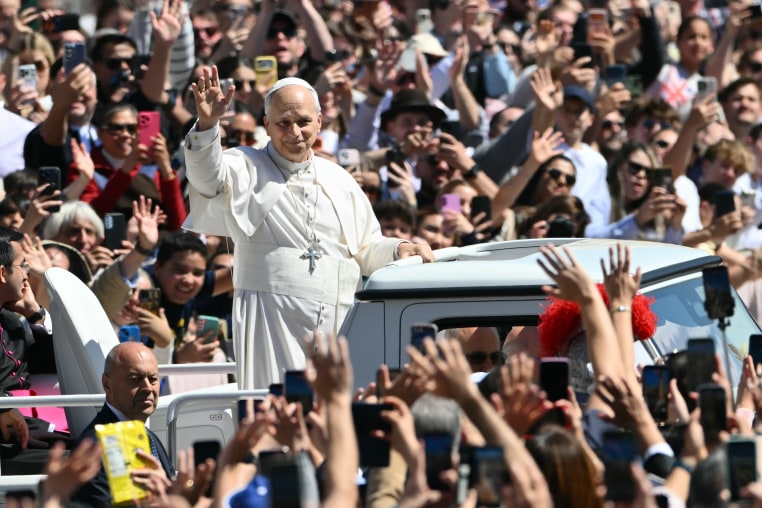 Pope Leo XIV waves to the crowd from the popemobile after the Easter Mass as part of the Holy Week celebrations, at St Peter's square in the Vatican on April 5.