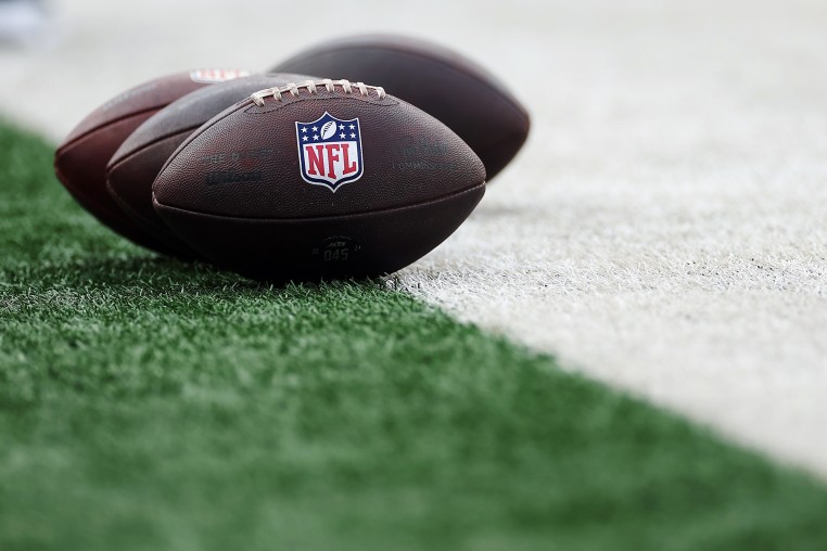 Detail of Wilson footballs with the NFL logo set on the football field