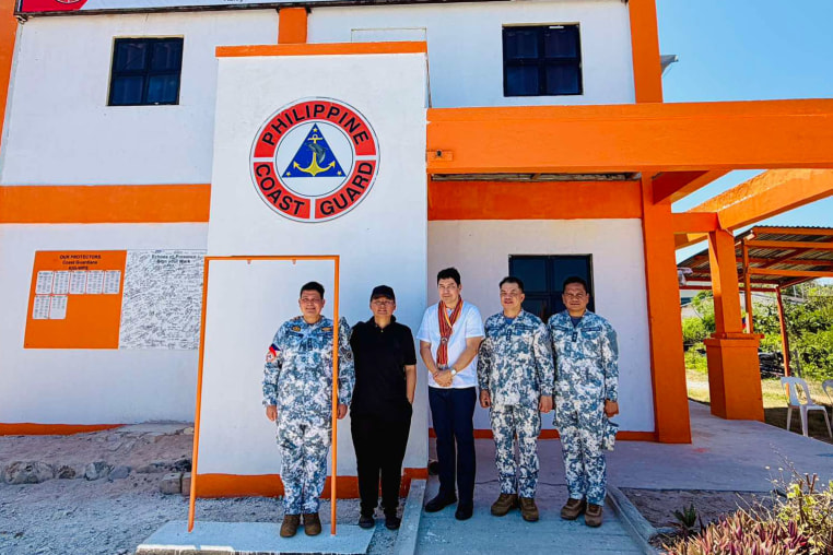 Senator Erwin Tulfo, center, poses with Philippine Coast Guard Admiral Ronnie Gil Gavan, second from right, on Thitu Island in the South China Sea 