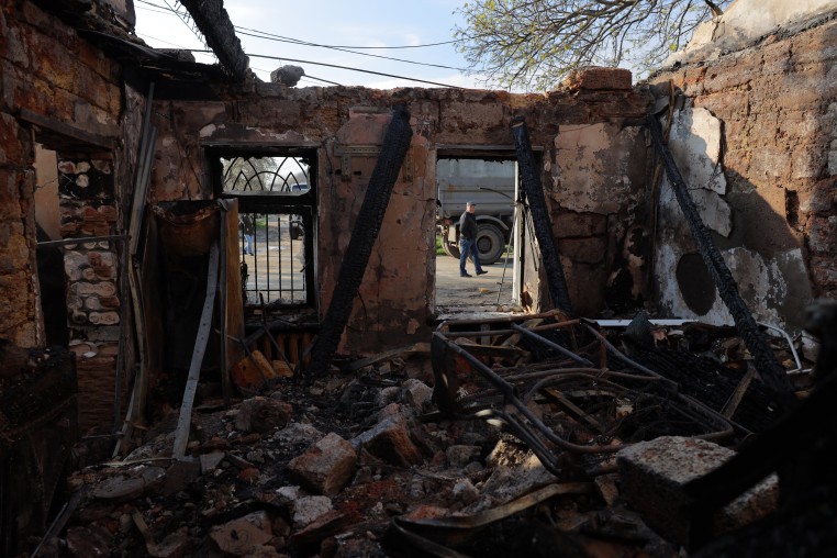 A local resident walks past a destroyed house following an air attack in Odesa on April 11.