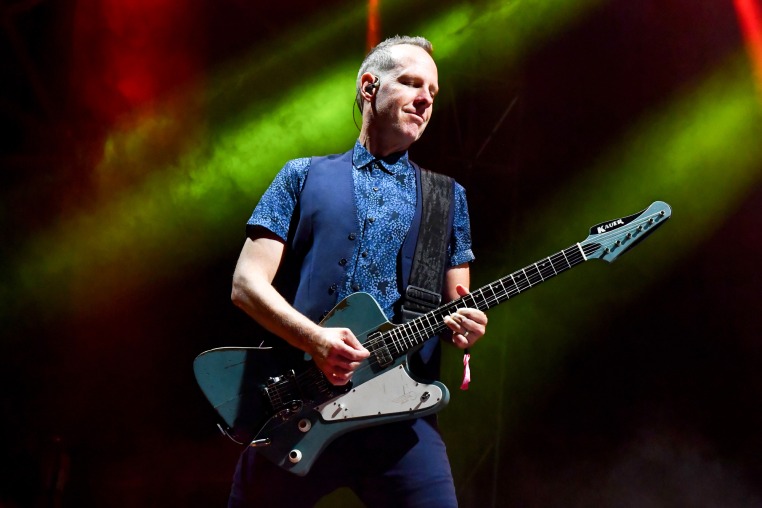 Tom Dumont plays guitar on stage