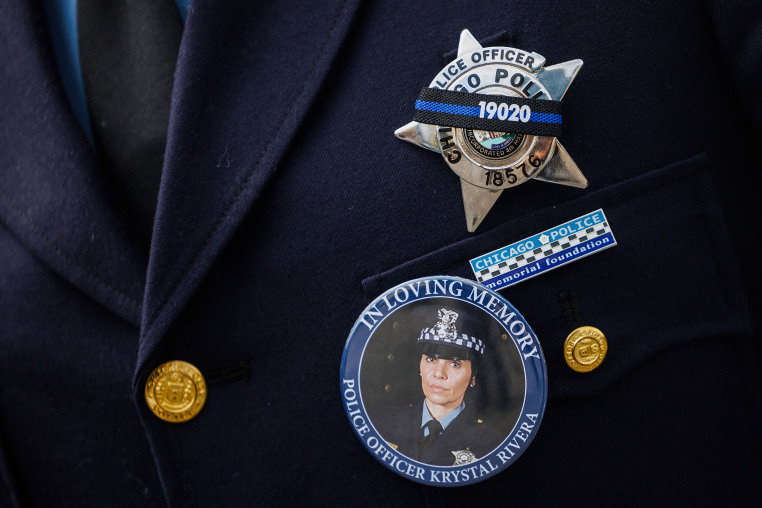 An officer wears a button showing slain Chicago police Officer Krystal Rivera.
