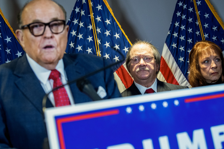 Joseph diGenova stands behind Rudy Giuliana during a press conference.