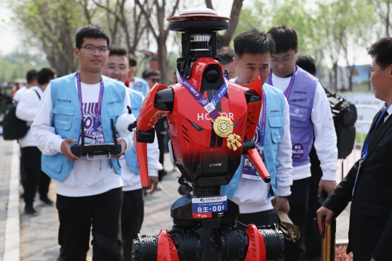 Winner The "Blitz" robot from smartphone manufacturer Honor accept media interviews after the 2026 Beijing E-Town Humanoid Robot Half-marathon on April 19.
