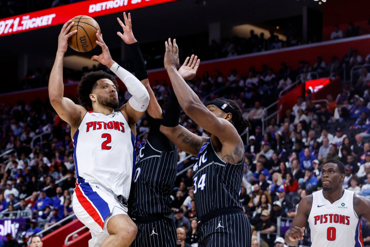 Cade Cunningham goes to the basket on Orlando Magic center Wendell Carter Jr.
