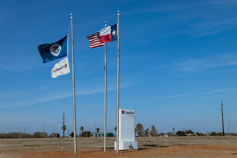 A Department of Homeland Security flag flies alongside the U.S. and Texas flags at the South Texas Family Residential Center