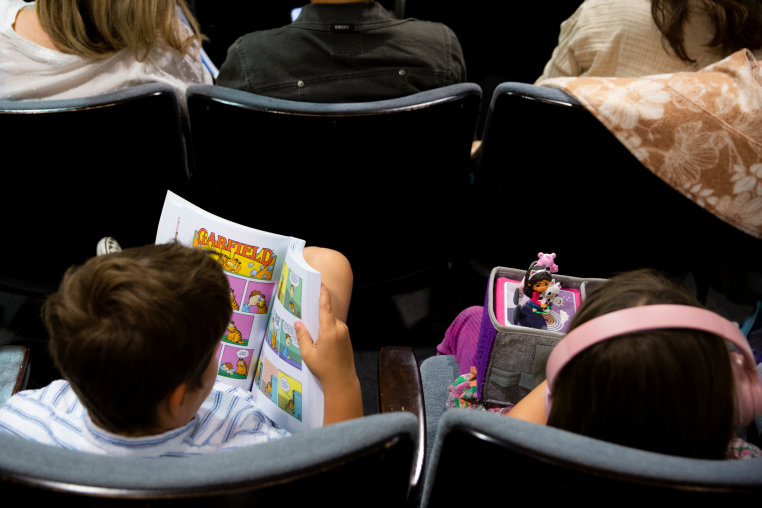 A child holds a Garfield comic book during an LAUSD board meeting in Los Angeles, on April 21, 2026.
