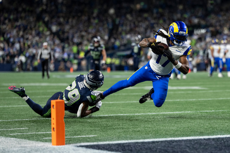 Davante Adams of the Los Angeles Rams dives with a ball against Josh Jobe of the Seattle Seahawks