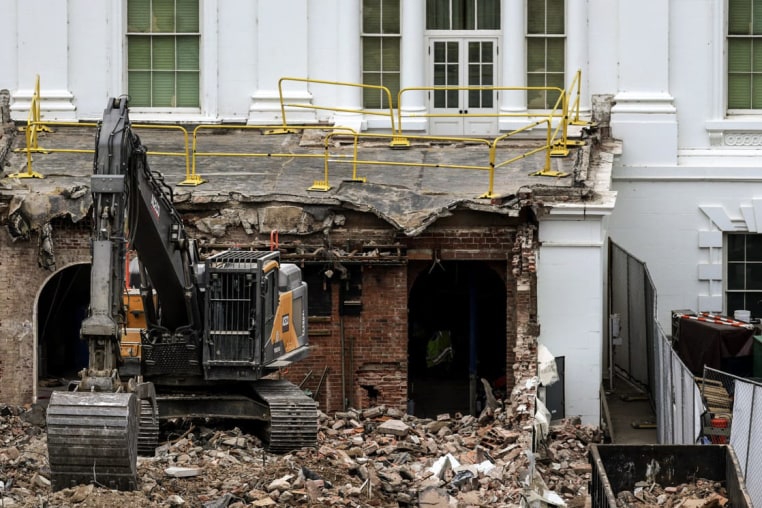 An excavator sits on the rubble after the East Wing of the White House was demolished in Washington, Oct. 28, 2025.