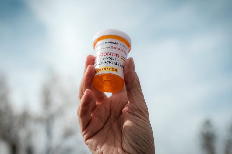 A protestor holds a bottle of oxycontin