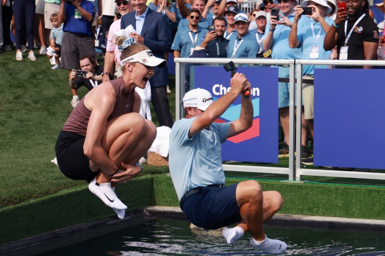 HOUSTON, TEXAS - APRIL 26: Nelly Korda of the United States and caddie Jason McDede jump into Poppie's Pond after winning The Chevron Championship 2026 at Memorial Park Golf Course on April 26, 2026 in Houston, Texas. (Photo by Sarah Stier/Getty Images)