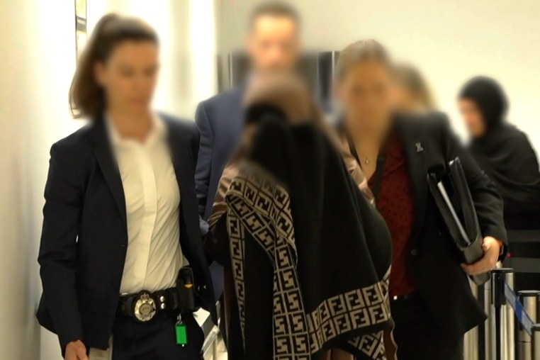 Two women charged with crimes against humanity offences allegedly committed in Syria, are pictured after being arrested on arrival into Melbourne, Australia.