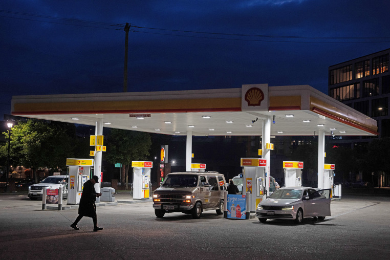 A person walks past a gas station on Wednesday, May 6, 2026, in Portland, Ore.