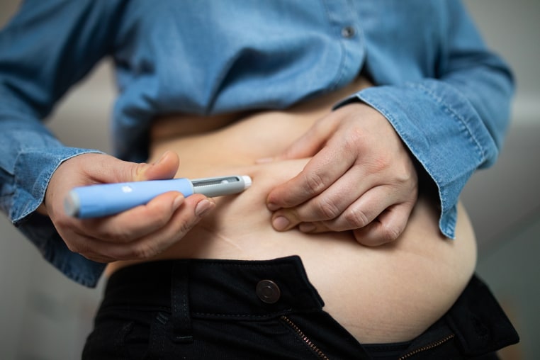 Image: Close-up of a person administering semaglutide injection for weight loss.
