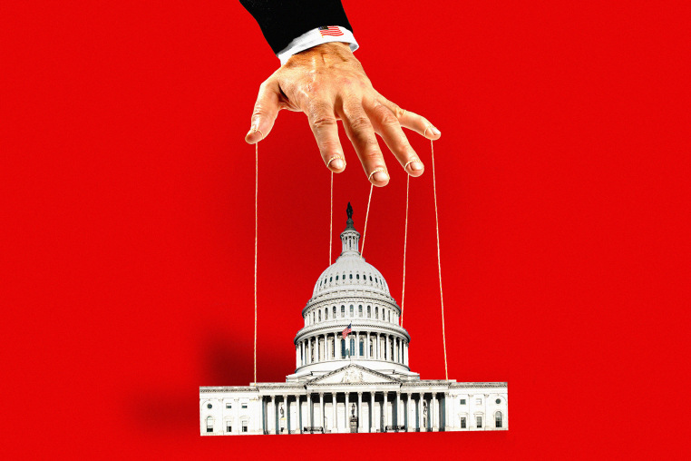 Photo illustration of a hand holding puppet strings above U.S. Capitol 