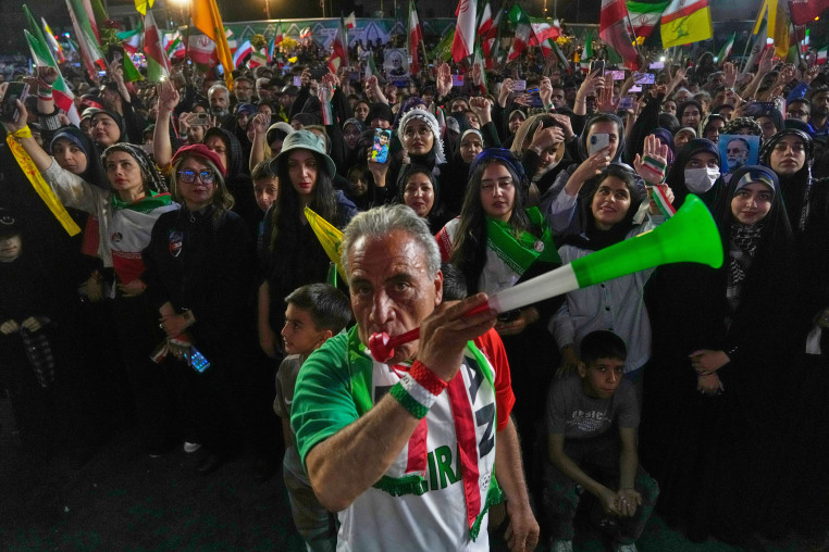 A man blows a plastic trumpet during a rally in support of Iran's World Cup team in Tehran on May 13, 2026.