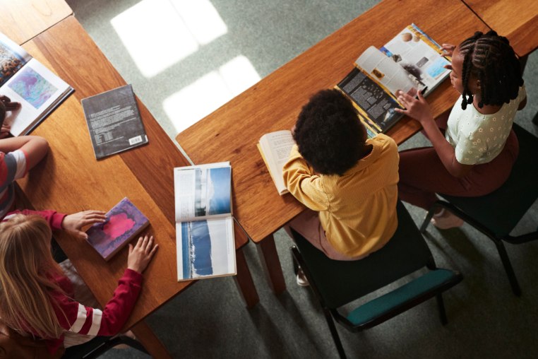 High angle view of students reading books