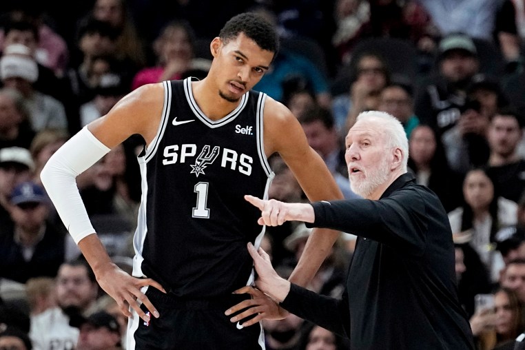 San Antonio Spurs head coach Gregg Popovich, right, talks with center Victor Wembanyama (1) during the first half of an NBA basketball game against the Los Angeles Lakers in San Antonio, Wednesday, Dec. 13, 2023.