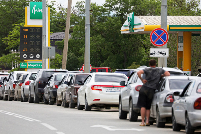 Cars queue for fuel at a gas station in Saki