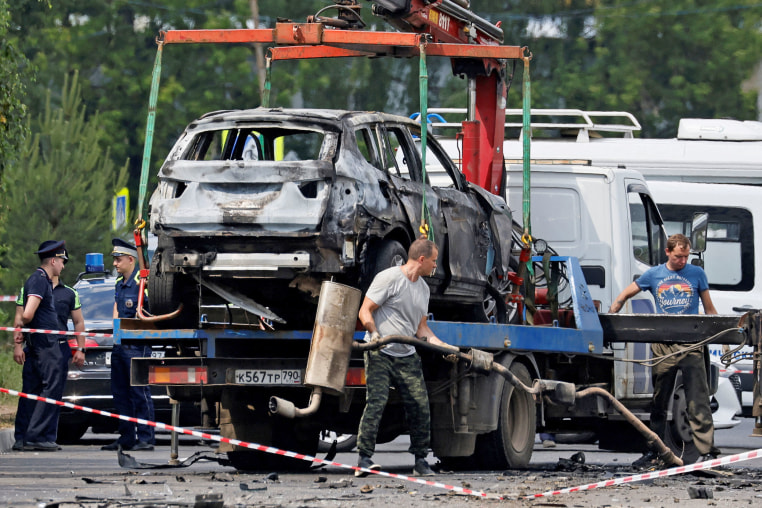 Investigators work at the scene of a car explosion in Balashikha