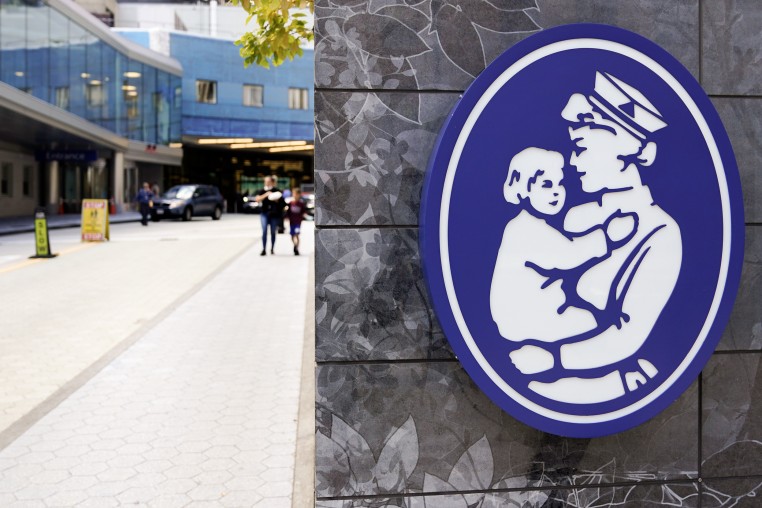 The logo of a nurse holding a child hangs on a wall outside the Boston Children's Hospital, on Aug. 18, 2022.