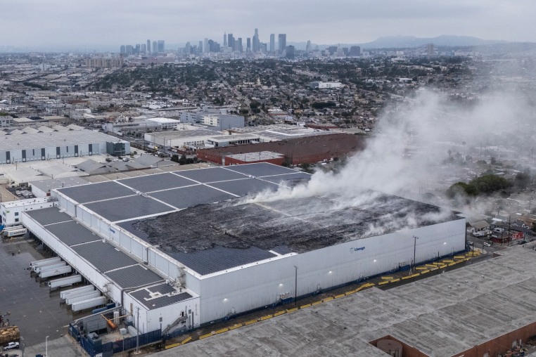 Image: The roof continued to smolder at a Lineage Logistics cold storage facility in Boyle Heights, Los Angeles, on June 18, 2026.