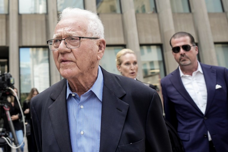 Frank stronach, outside a courthouse.