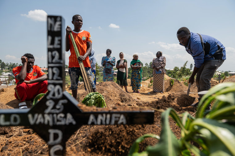 Relatives of Vanisa Anifa, a 6-month-old orphaned girl who died of Ebola, attend her burial.