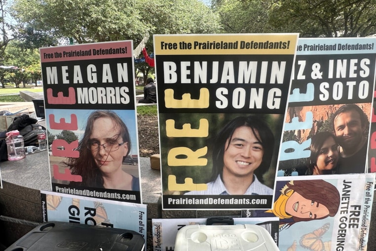Posters with the faces of protesters accused by the Justice Department of having ties to antifa.