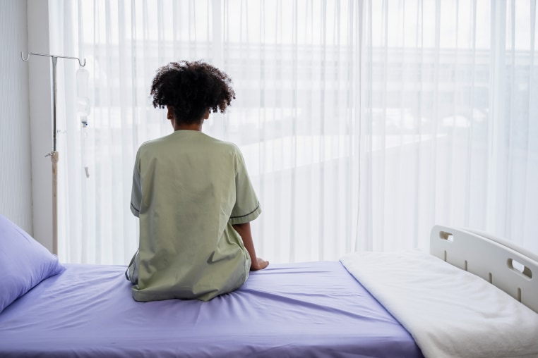 Lonely patient sitting on the hospital bed