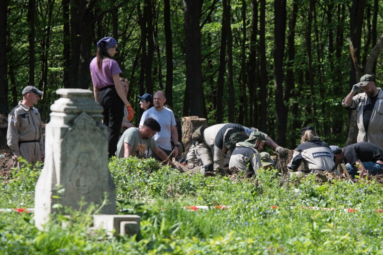 Polish archaeologists work at the exhumation site of the World War II Volhynia massacre 