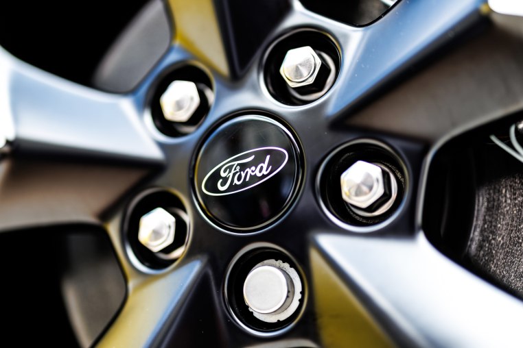 A Ford logo in the center of the rim of a wheel