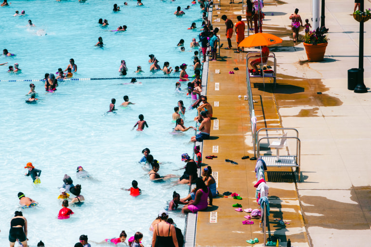 People swims at a public pool in New York City.